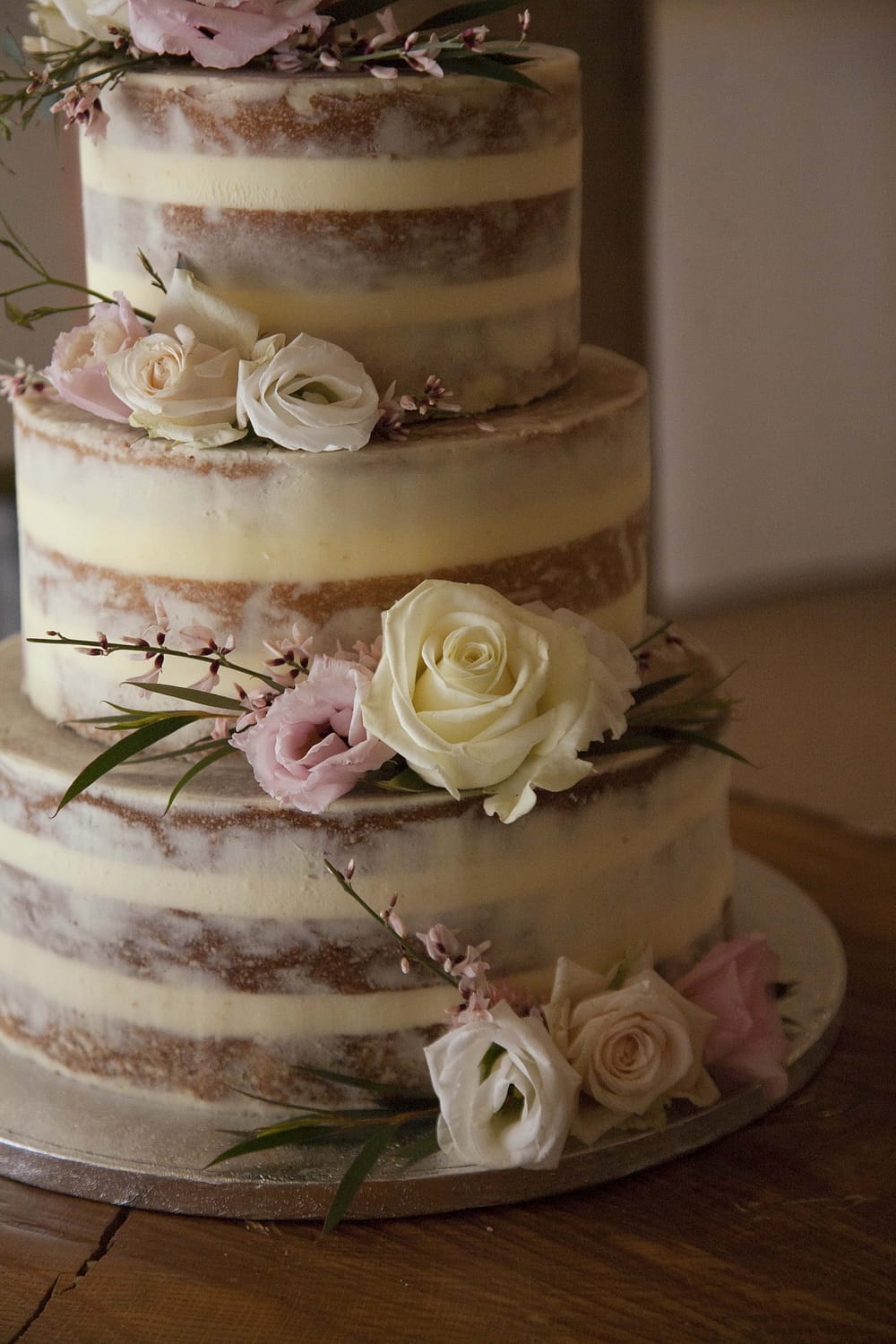 semi naked cake with blush pink and white roses