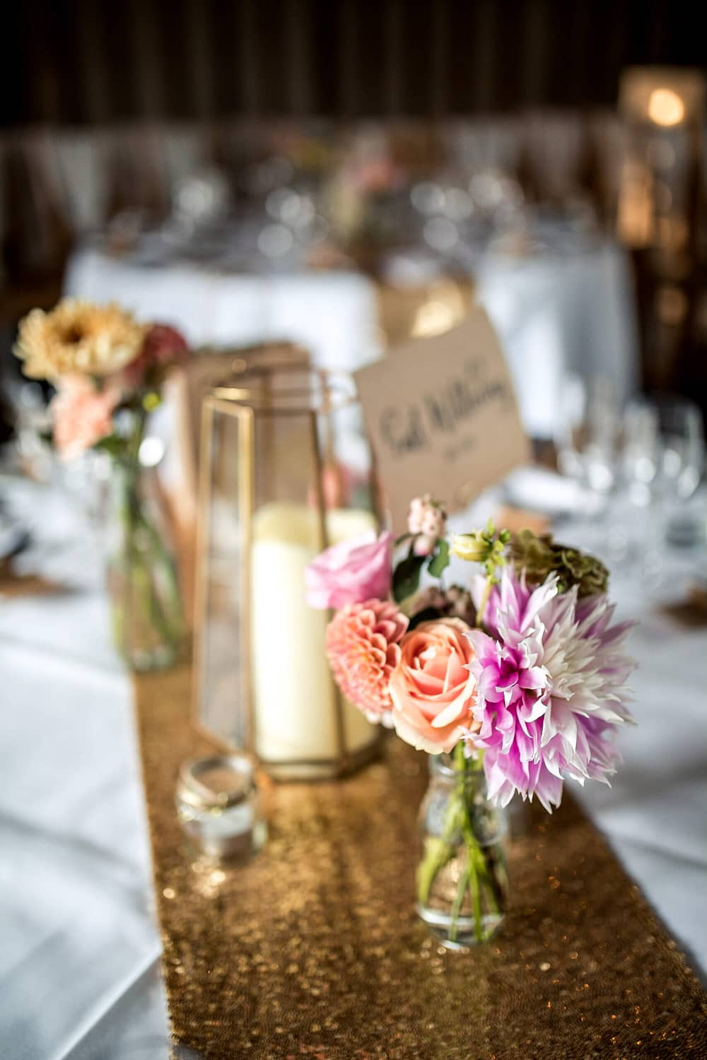 gold table settings with flowers and lanterns at southend barns