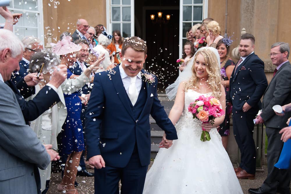 Nonsuch mansion april wedding, bride and groom and confetti