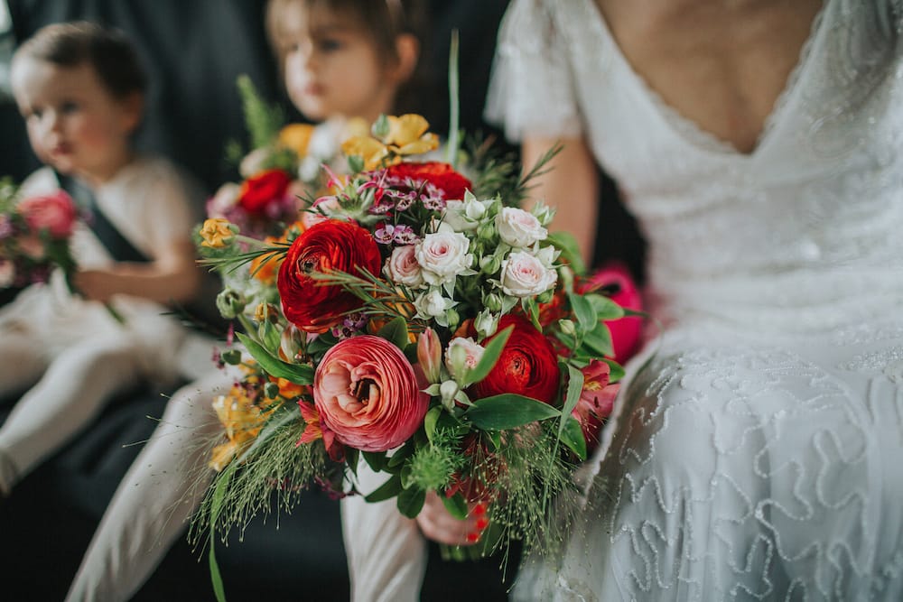 red, orange and green spring wedding bouquet by Bette Rose Brighton