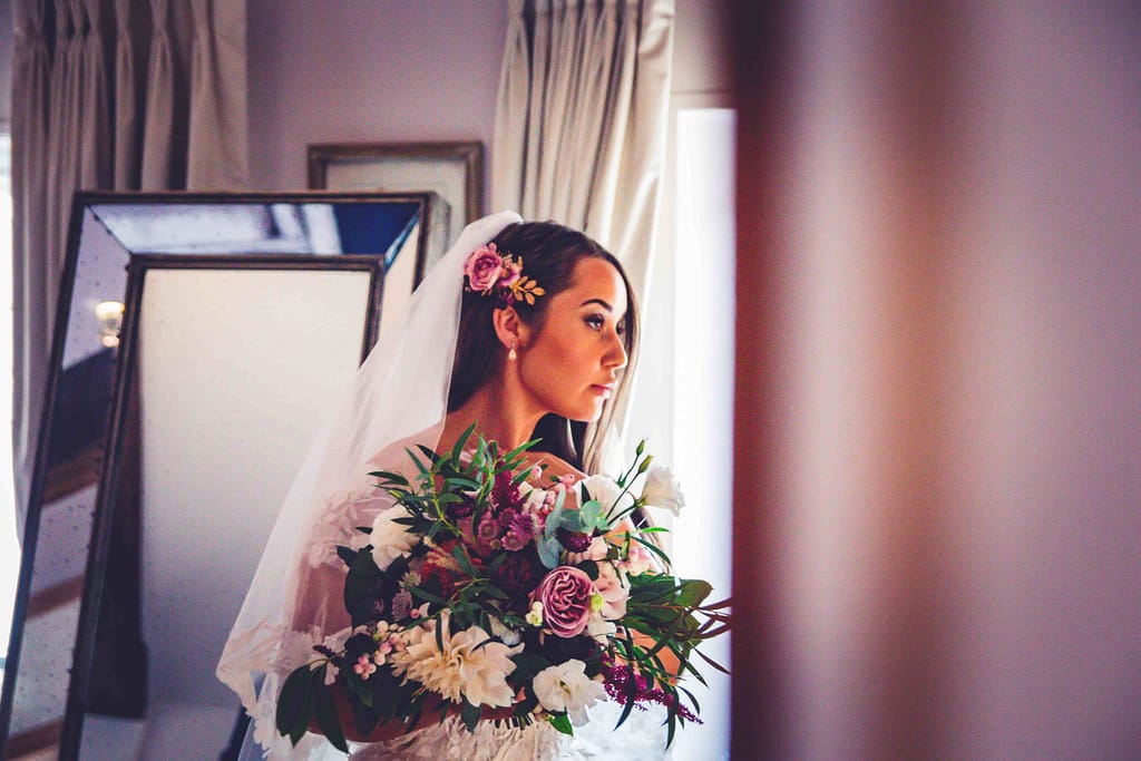 bride with her bouquet full of autumn flowers at pelham house in Lewes