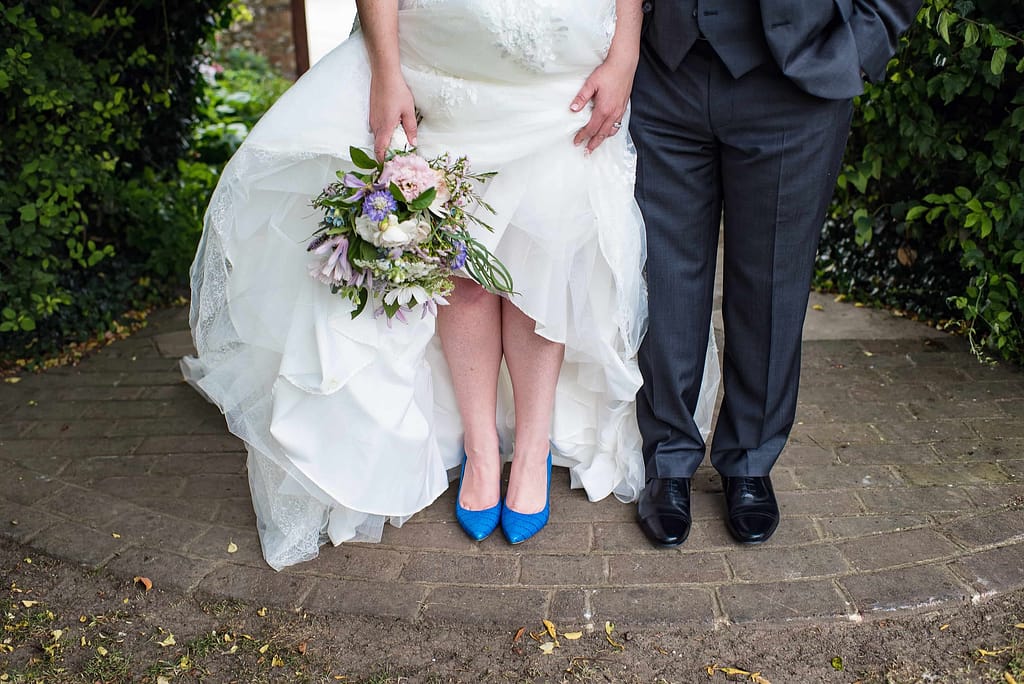 bride with white dress and blue shoes