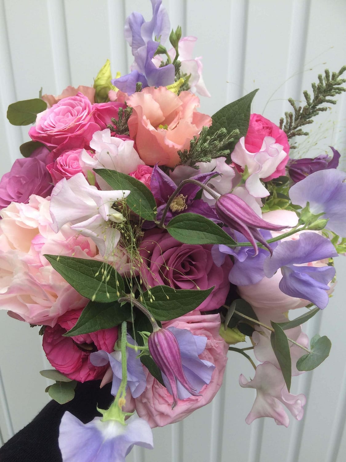 pink and purple bouquet with peonies, roses, sweet peas, clematis and lisianthus