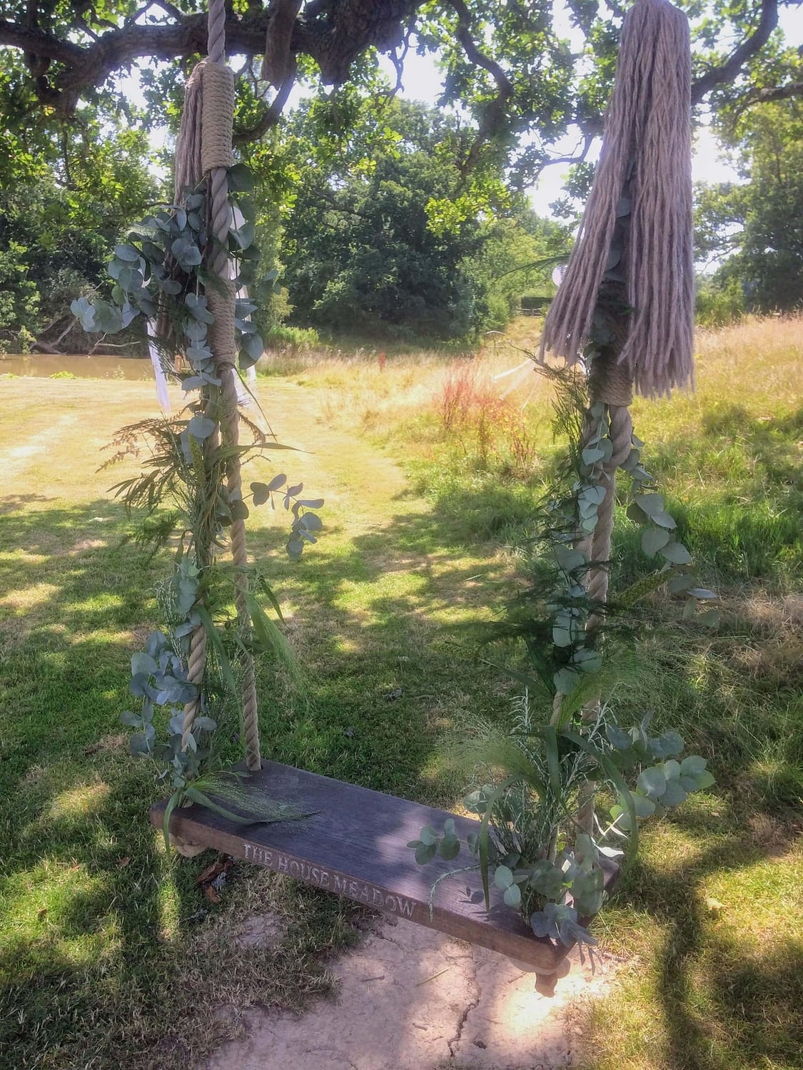 foliage decorated swing at the house meadow