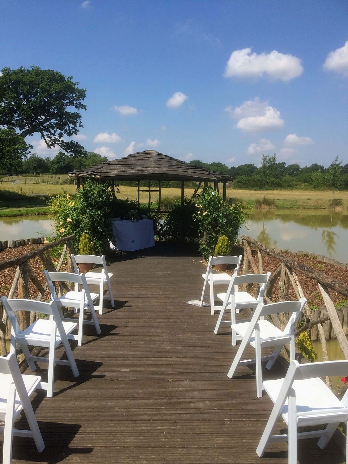 summer wedding, outdoor ceremony by the lake at the house meadow