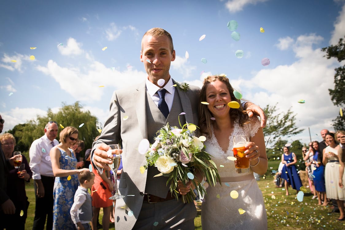 festival wedding bride and groom with confetti