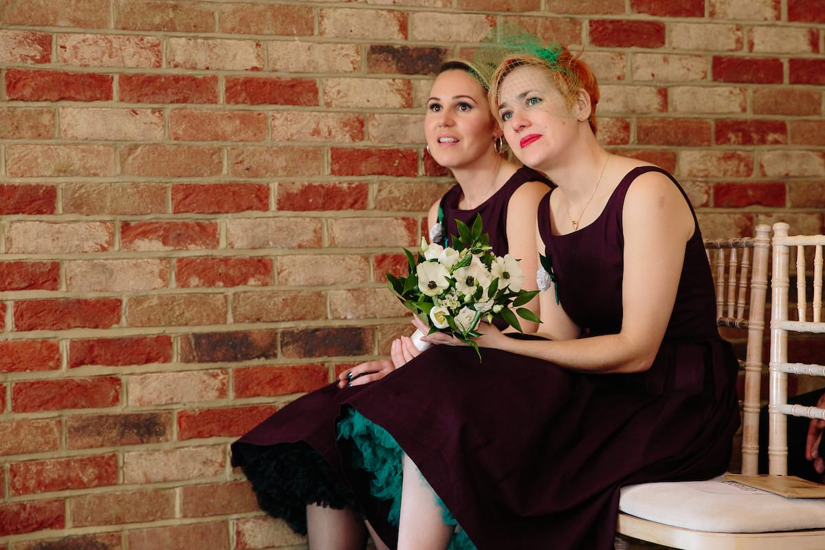 plum coloured bridesmaids dresses with green petticoats. Art Deco style wedding