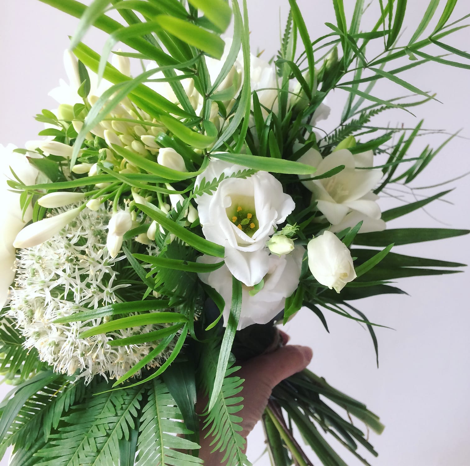 white and green bridal bouquet with ferns for a june wedding