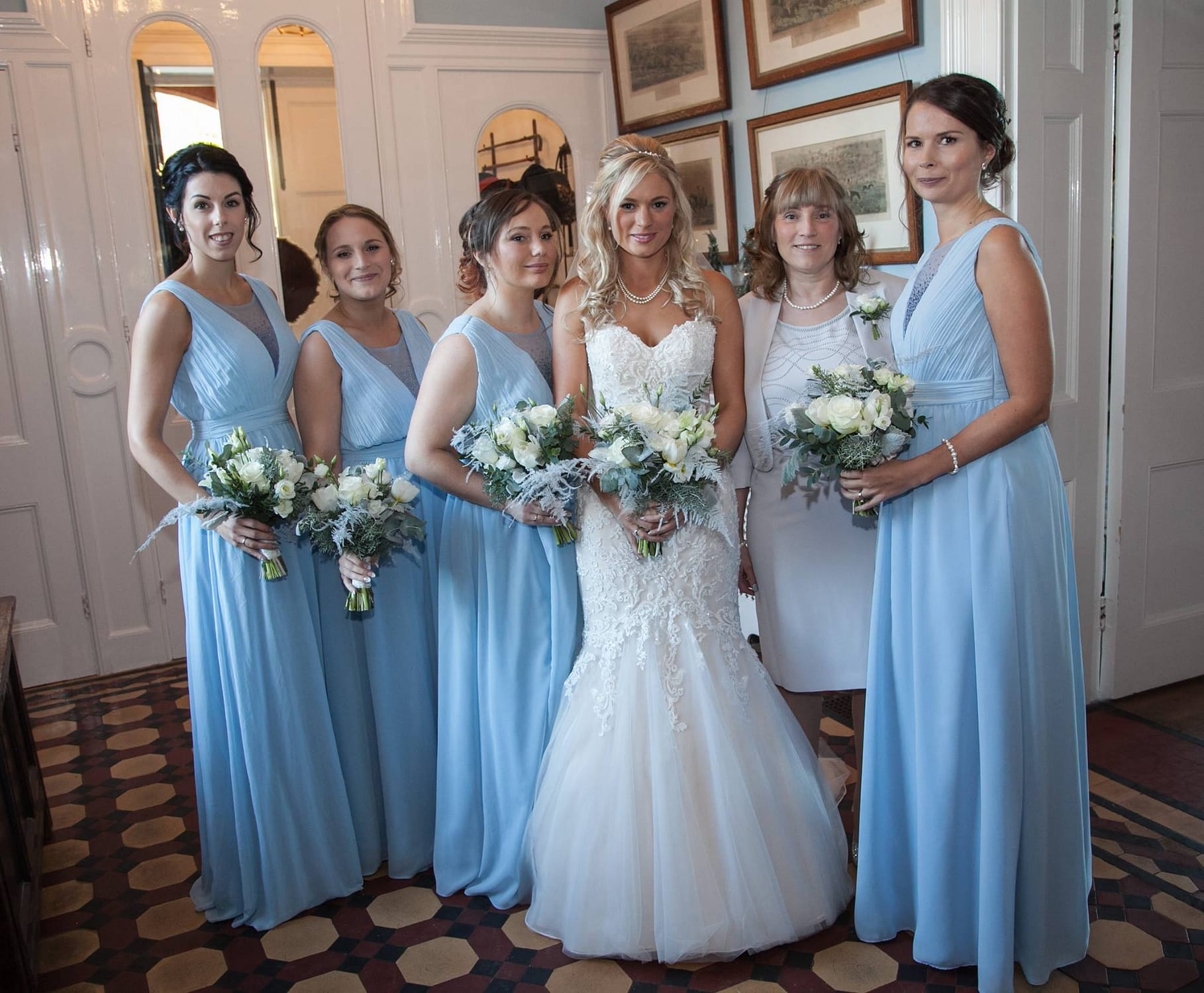 Winter wedding flowers sussex. Bride and bridesmaids in frozen ice blue dresses