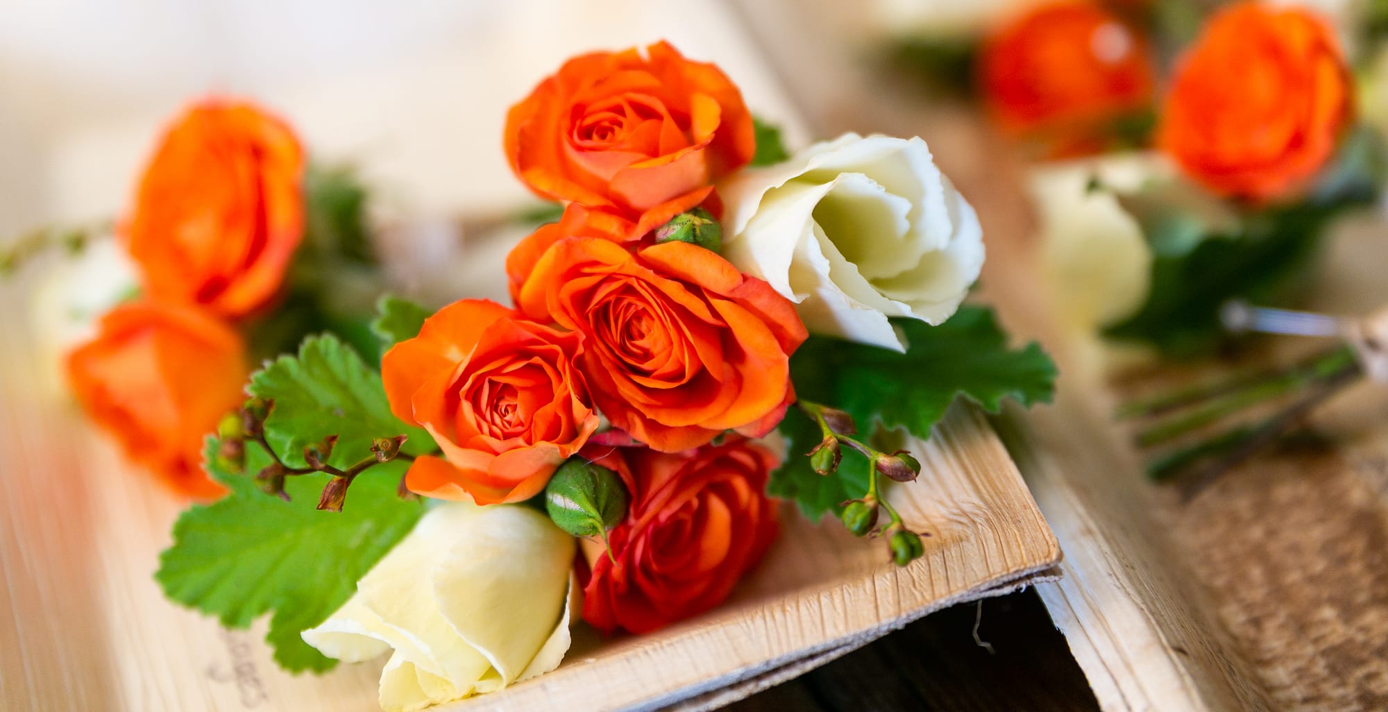 orange spray rose and lisianthus buttonhole