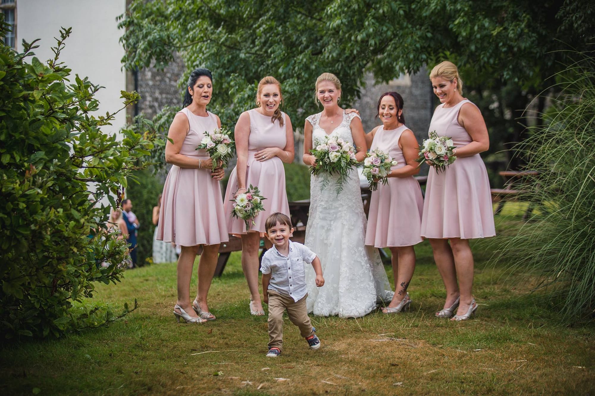 blush bridesmaids dresses and flowers