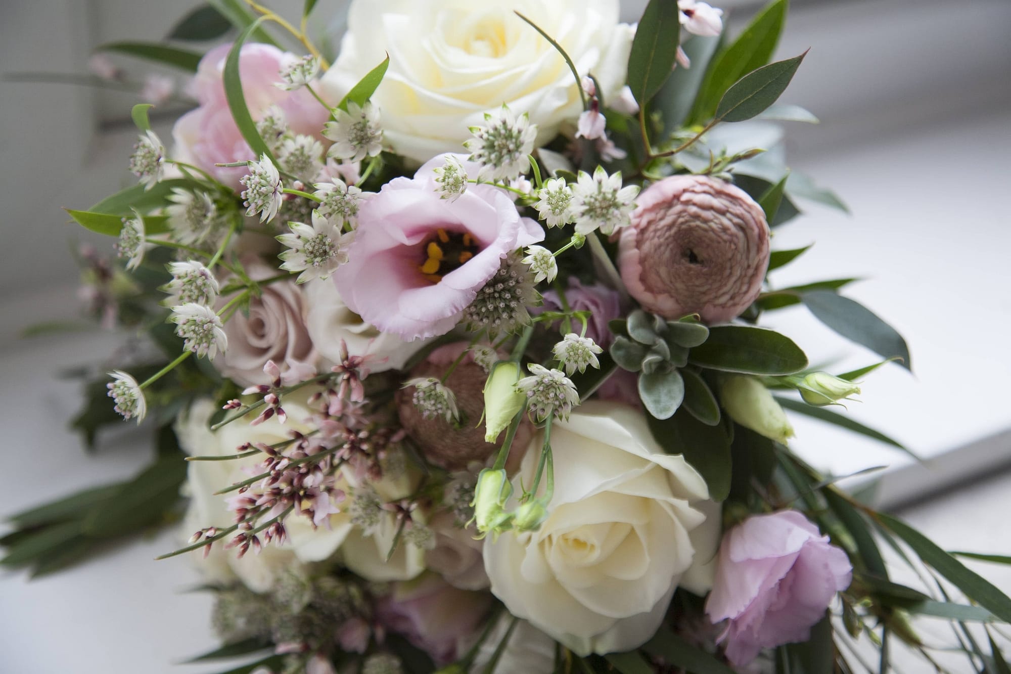 blush pink ranunculus, white roses, eucalyptus and lisianthus. April bridal bouquet.