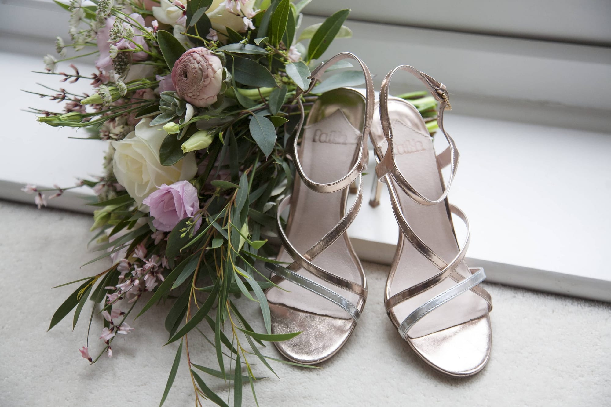 bridal bouquet and metallic rose gold shoes