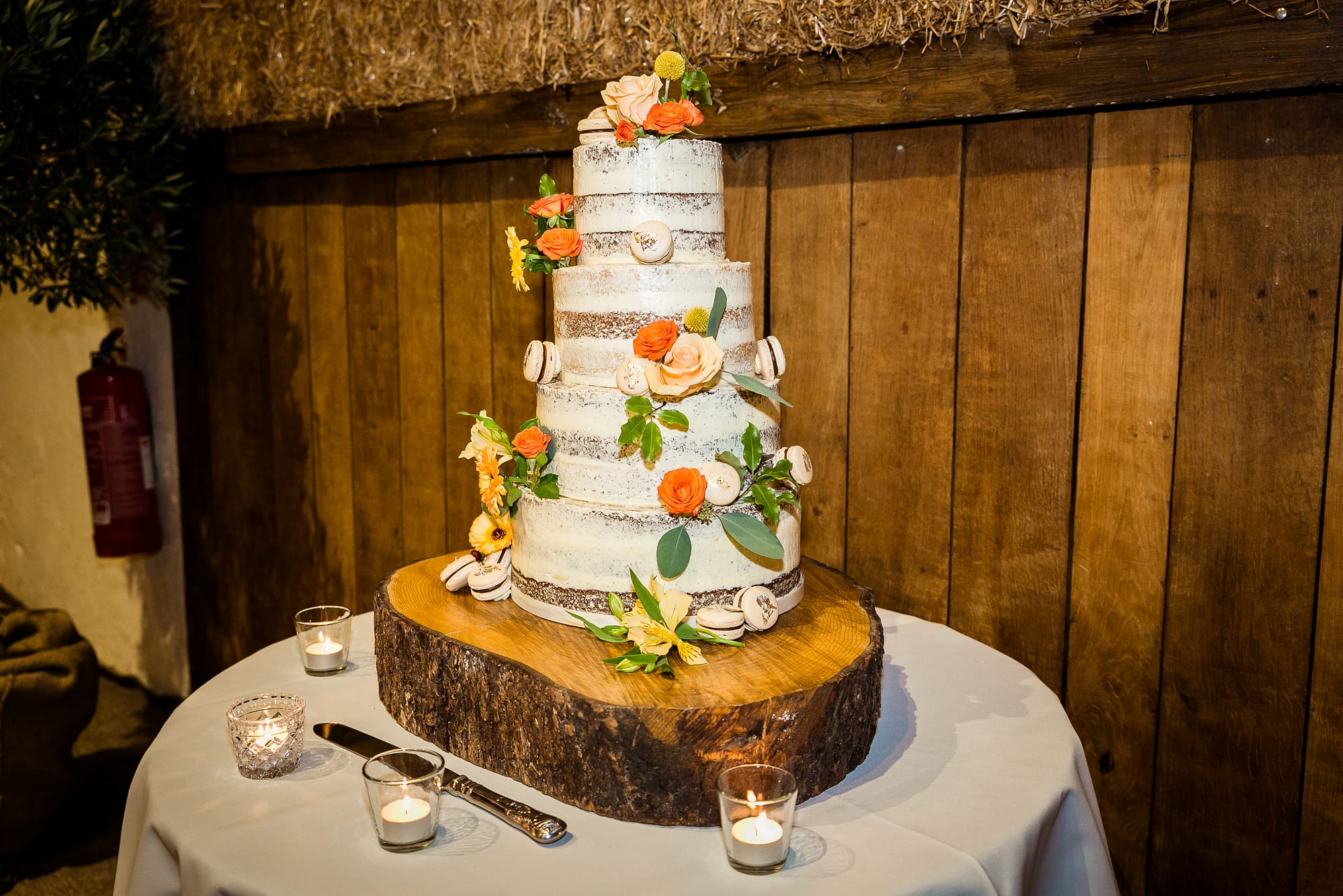 wedding cake with orange and peach roses at pangdean barn brighton