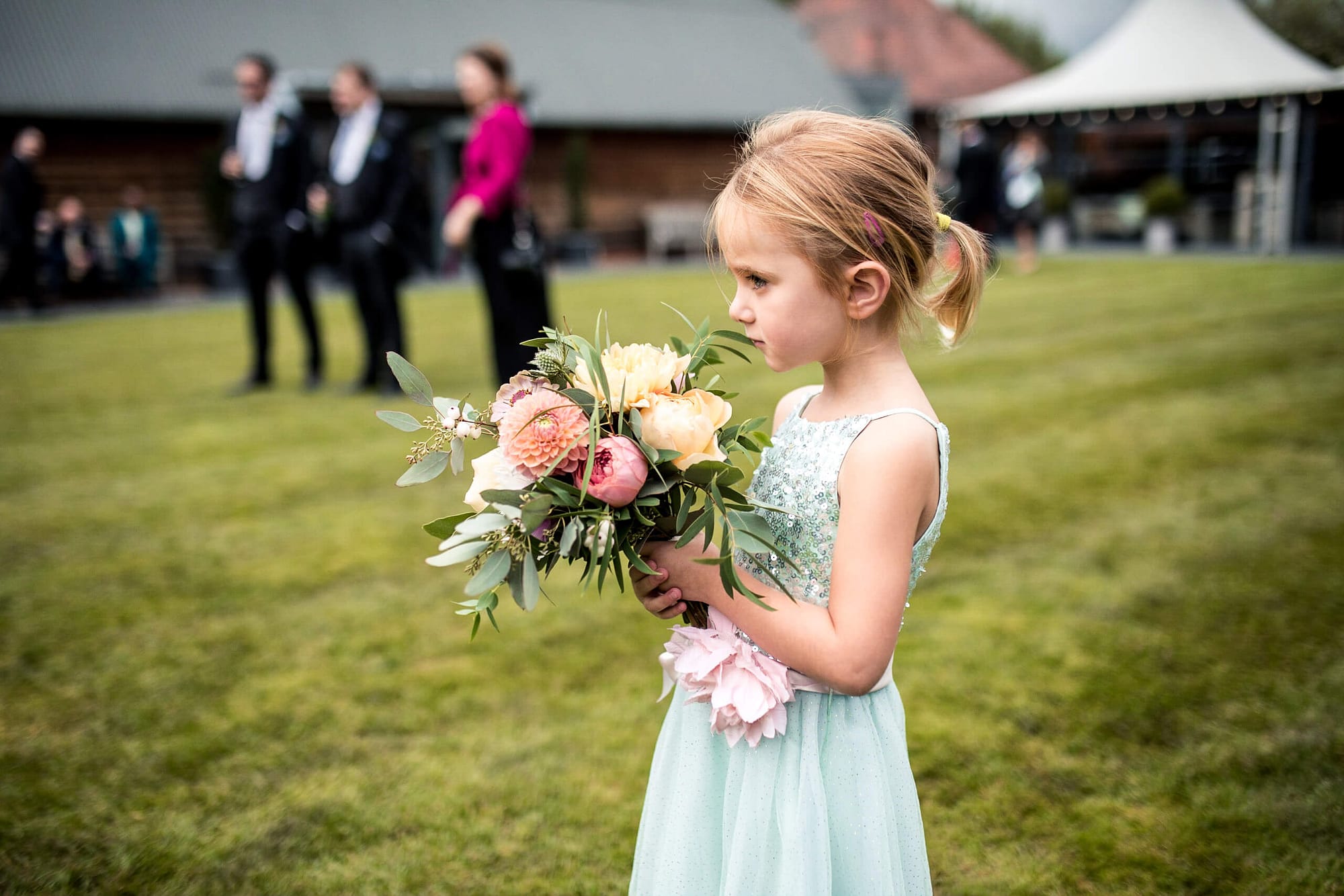 little flower girl with bouquet of flowers at southend barns