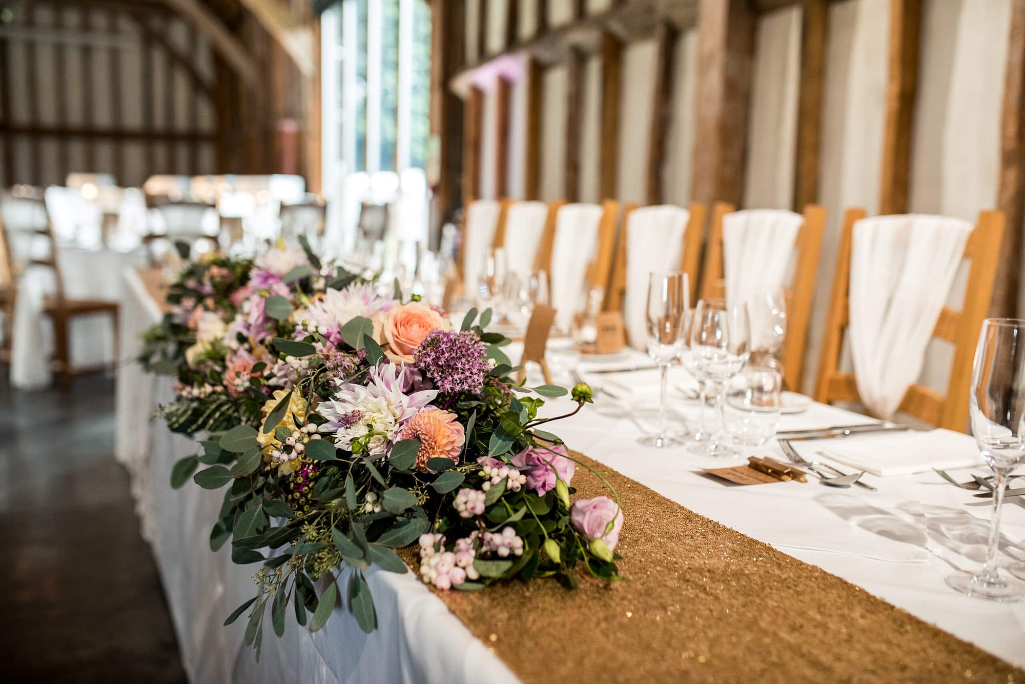 top table flowers with gold table runners at southend barns chichester