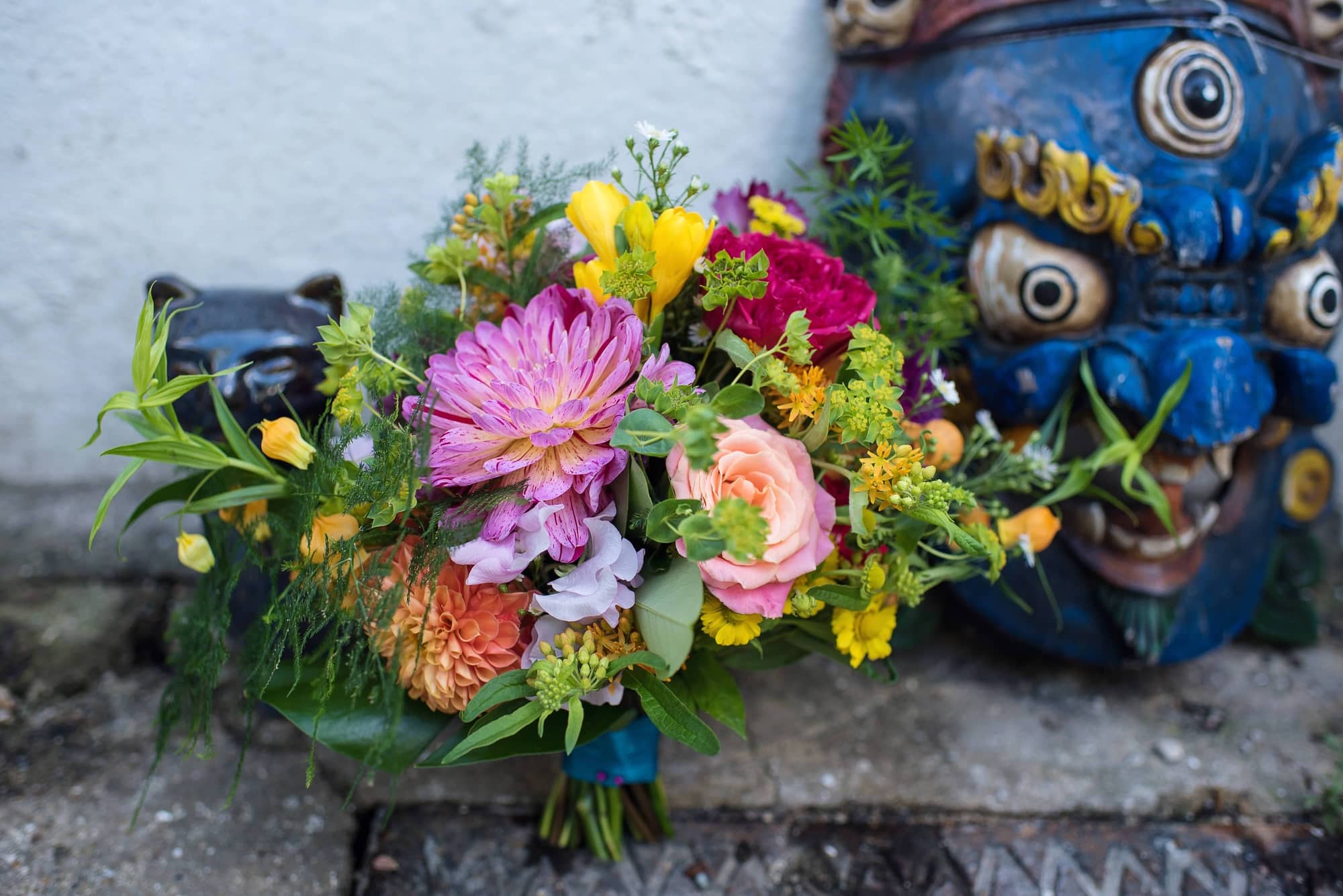 bridal bouquet and tiki mask