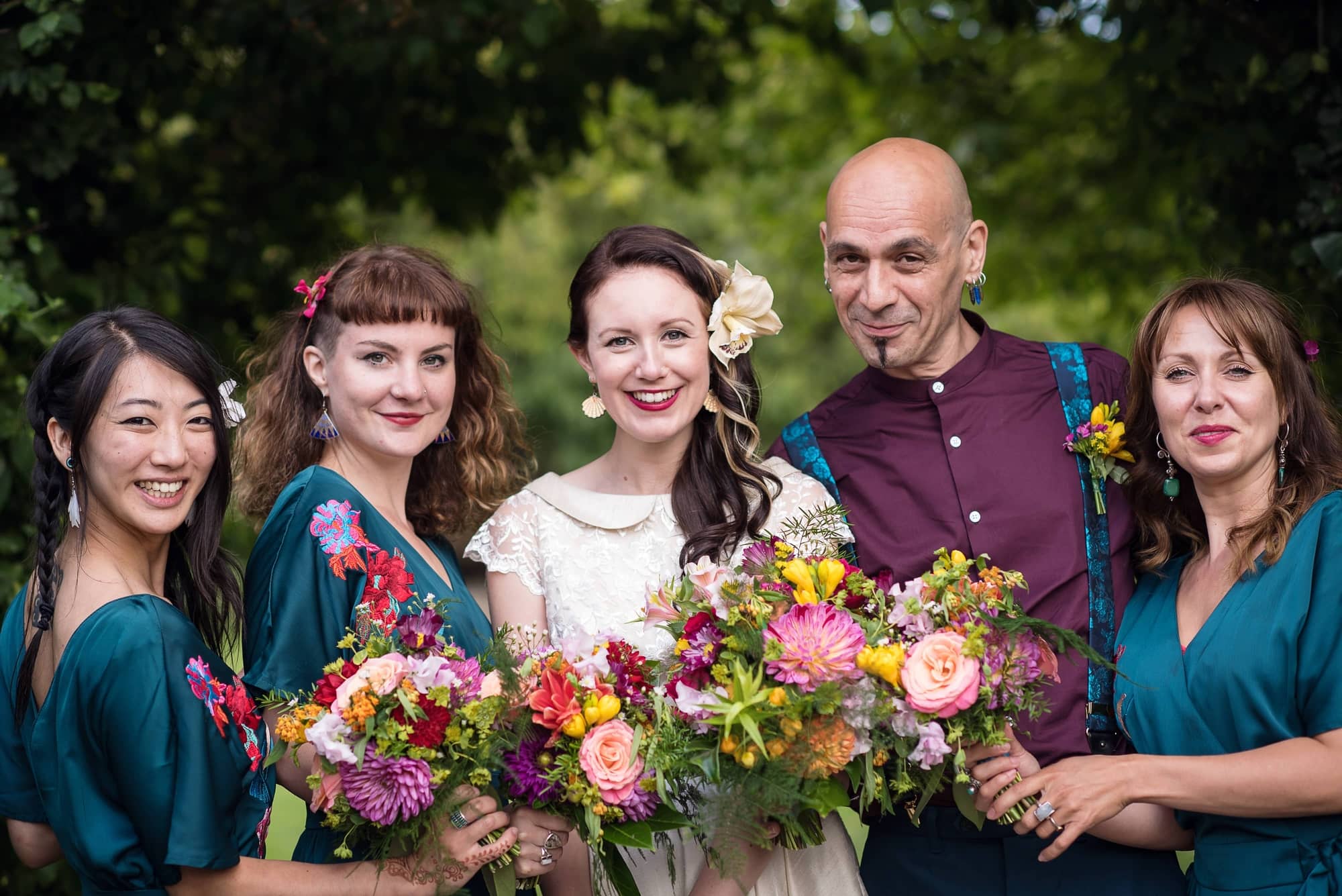 bride and bridesmaids with bright colourful bouquets