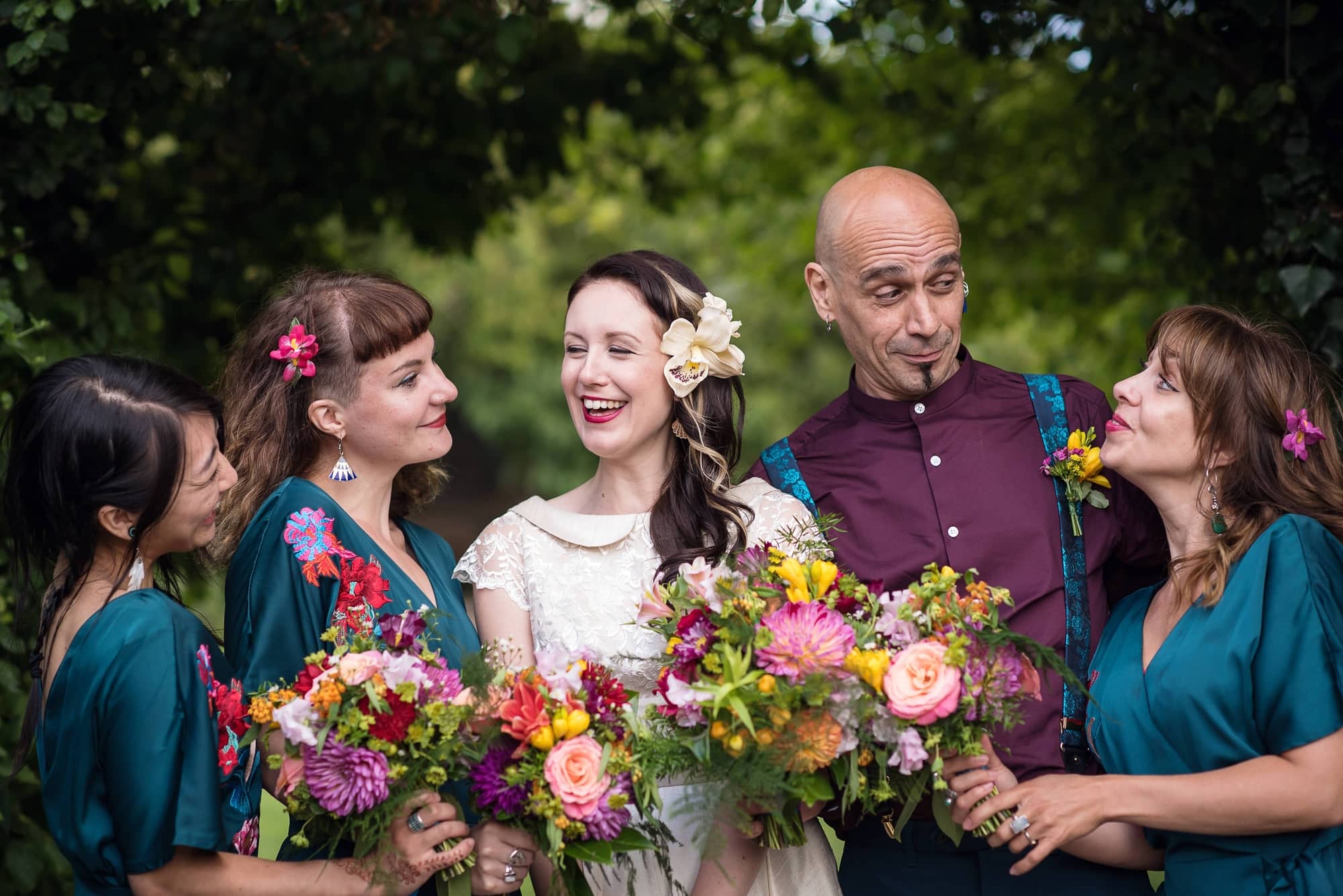 tattooed bridesmaids and bridesman with bright flowers
