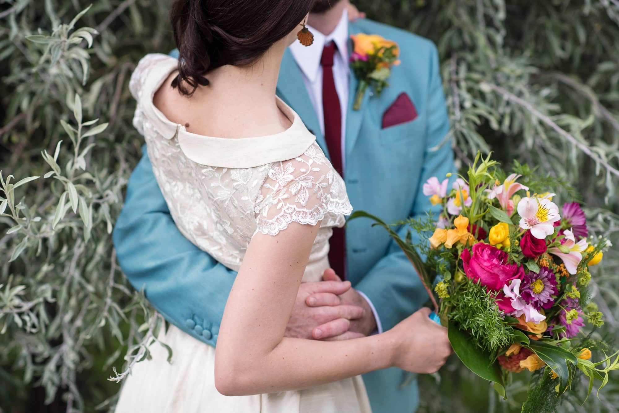 duck egg blue wedding suit in vintage inspired wedding with pink and orange flowers