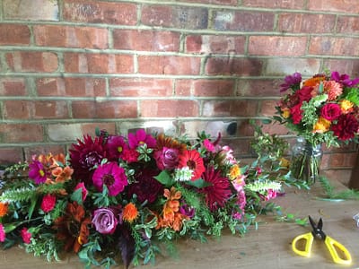 top table arrangement in hot pinks and oranges, autumn colours