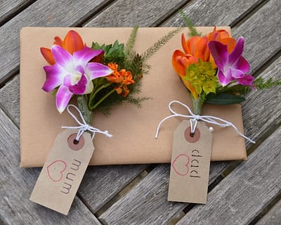 Corsages with orange, green and pink flowers - Surrey