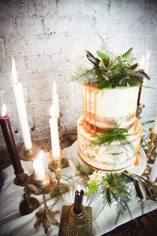 wedding cake table, candles and greenery