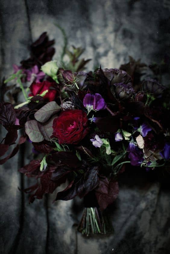 black bacarra roses, black pearl lisianthus with deep purples, plums and dark reds in this gothic bridal bouquet