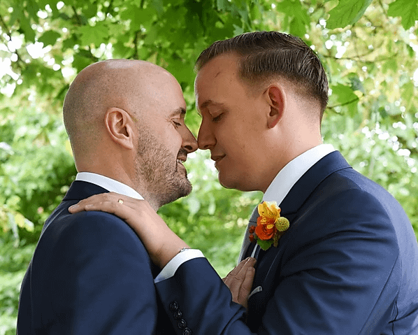 gay wedding at pangdean barn, two grooms just after they get married.