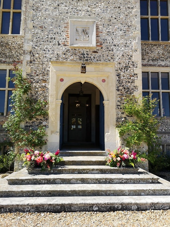 Glynde Place Wedding, entrance steps with flower arrangements