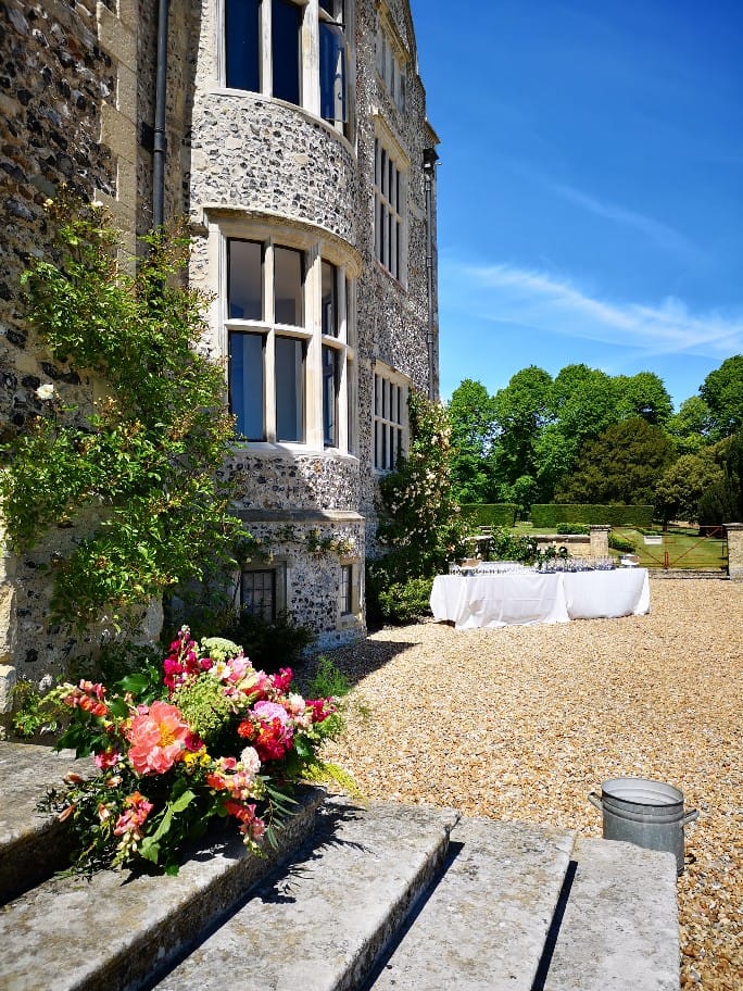 Glynde Place Wedding, outdoor drinks reception with flowers