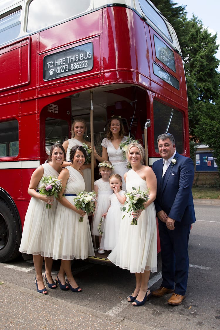 vintage wedding bus sussex with bridal party and flowers