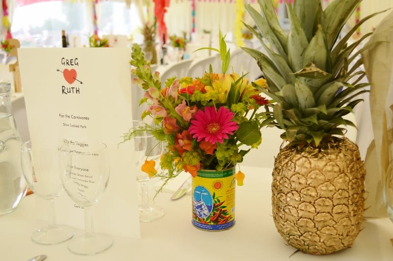 Tropical wedding flowers, gold pineapple table decorations.