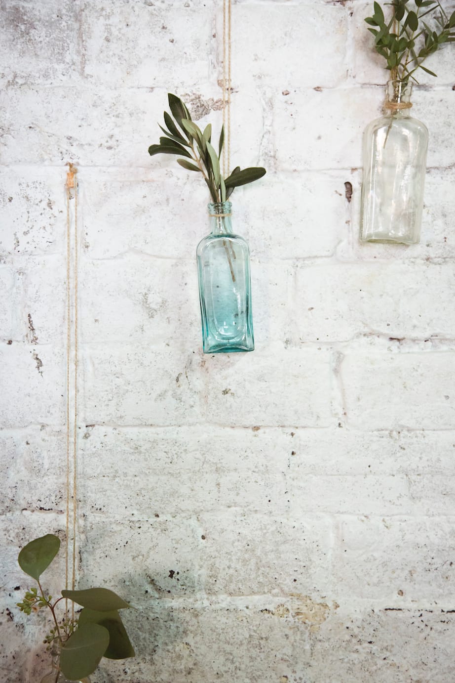 hanging flowers, apothecary bottles with olive foliage