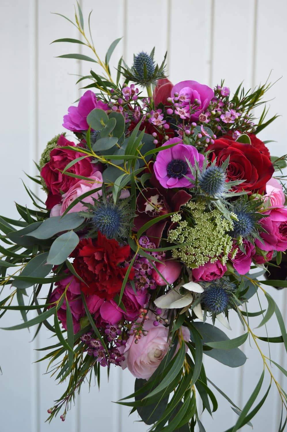 spring wedding bouque in deep reds and pinks