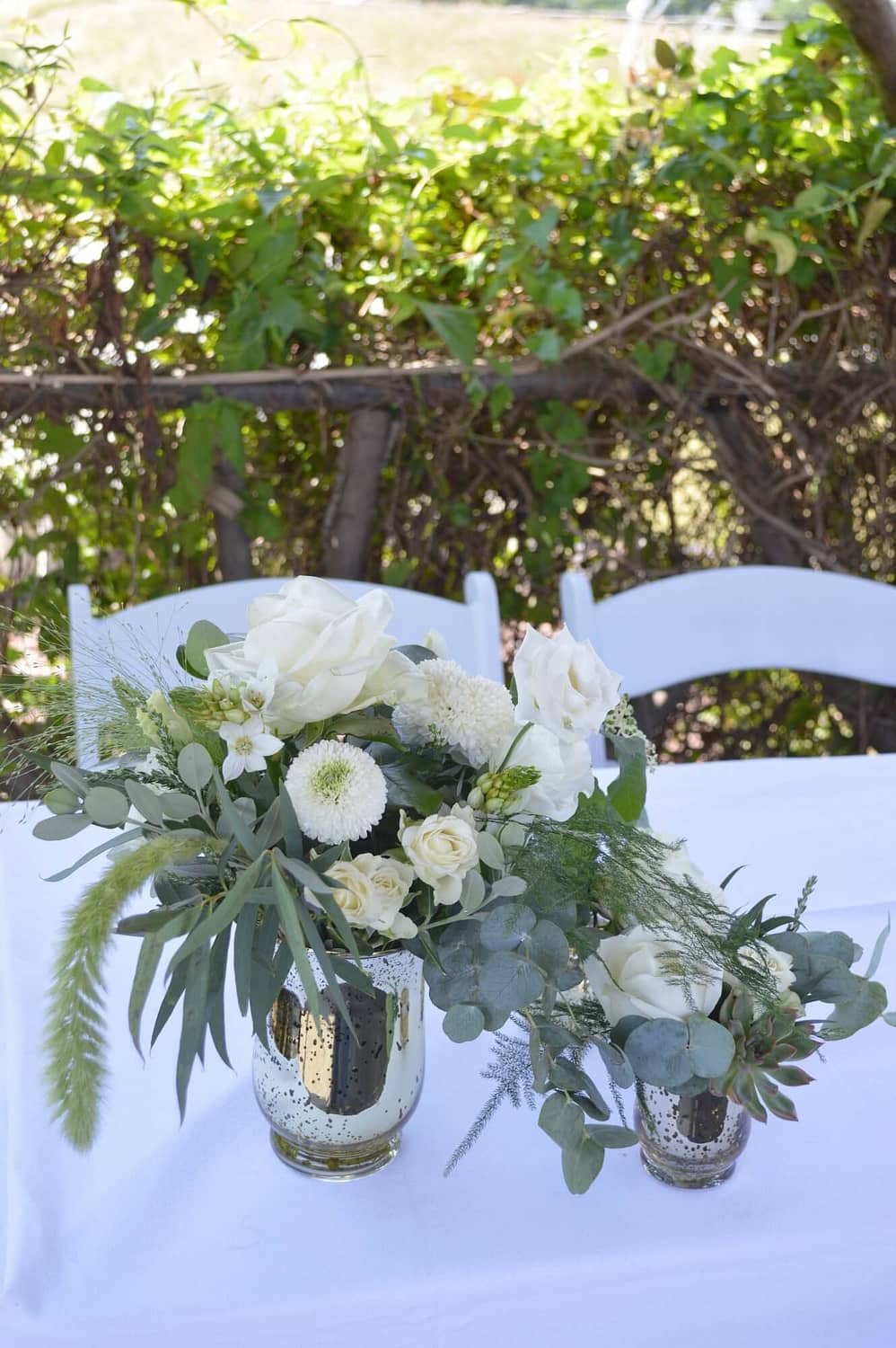 small gold vases with natural style white flowers and foliage