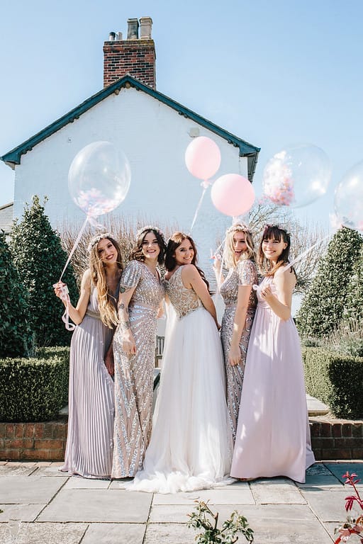 bride and bridesmaids with balloons at southend barns sussex