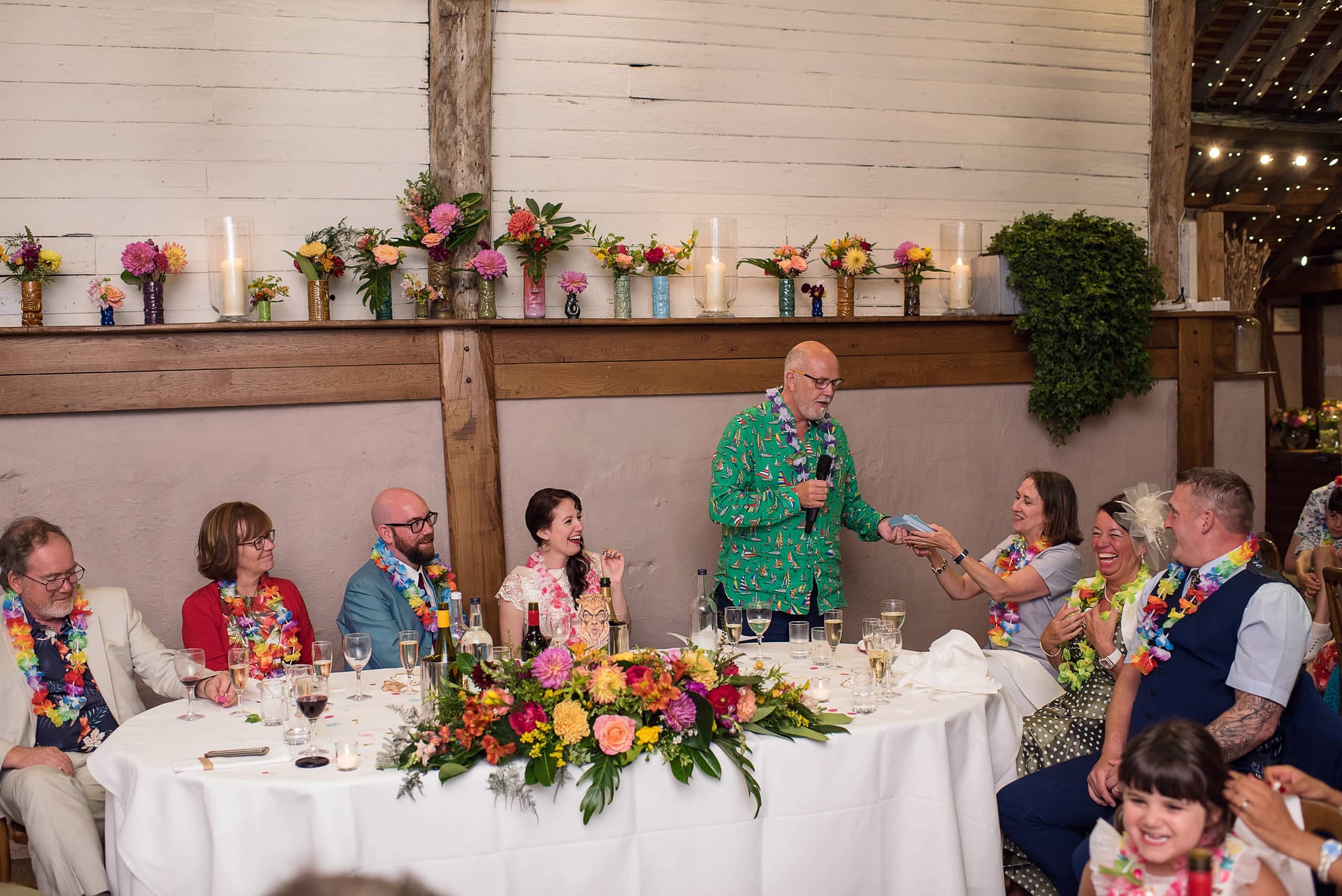 tropical Hawaiian wedding top table flowers with tiki mugs
