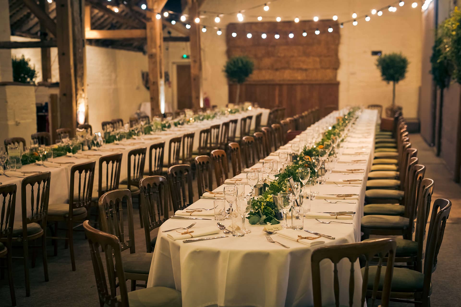 foliage garlands on long wedding tables at pangdean barn brighton